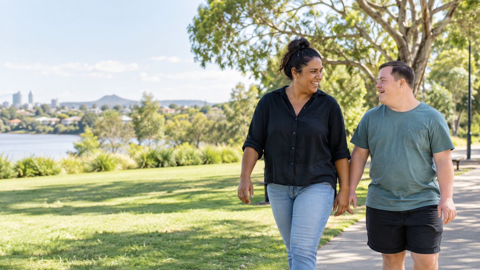 A support worker and participant enjoying time together in a Queensland park